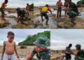 Personel Satgas TMMD Bermain dan Mencari Ikan Bersama Anak-anak Saat Air Laut Surut